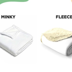 May include: Two folded blankets are displayed side by side. The left blanket is labeled MINKY and is solid white with a smooth texture. The right blanket is labeled FLEECE and features a white exterior with a textured, cream-colored interior lining.