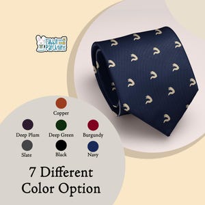 May include: A navy blue necktie featuring a repeating pattern of small, light-colored fox tail icons. The image includes a logo with a rabbit and the text Rabbit Patch Gifts, along with a color chart displaying seven different color options.