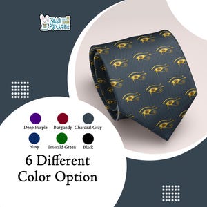 May include: A navy blue tie with a repeating gold eye of Horus pattern. The image also displays color options: deep purple, burgundy, charcoal gray, navy, emerald green, and black. Text reads "6 Different Color Option."