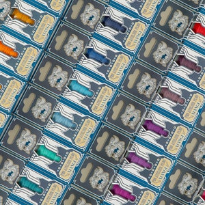 May include: A variety of colorful embroidery floss spools arranged in rows. Each spool is packaged in a blue and gold box with the word "VINTAGE" printed on it.