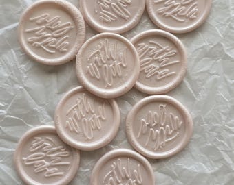May include: A collection of pale pink wax seals, each embossed with the words "with love" in elegant cursive script. The seals are circular and have a slightly textured appearance, suggesting a handmade quality. They are arranged on a textured, off-white surface.