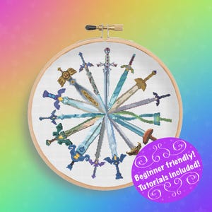 May include: A cross-stitch embroidery hoop featuring a circular design of various pixelated swords in shades of blue, gold, and green. The text "Beginner friendly! Tutorials included!" is on a purple sticker. The hoop is set against a rainbow gradient background.