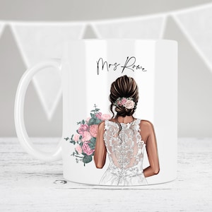 May include: White ceramic mug with a bride illustration holding a bouquet of pink and green flowers. The text "Mrs. Rowe" is printed on the mug.