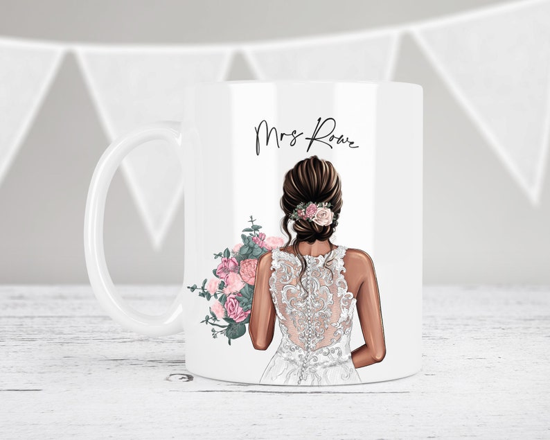 May include: White ceramic mug with a bride illustration holding a bouquet of pink and green flowers. The text "Mrs. Rowe" is printed on the mug.