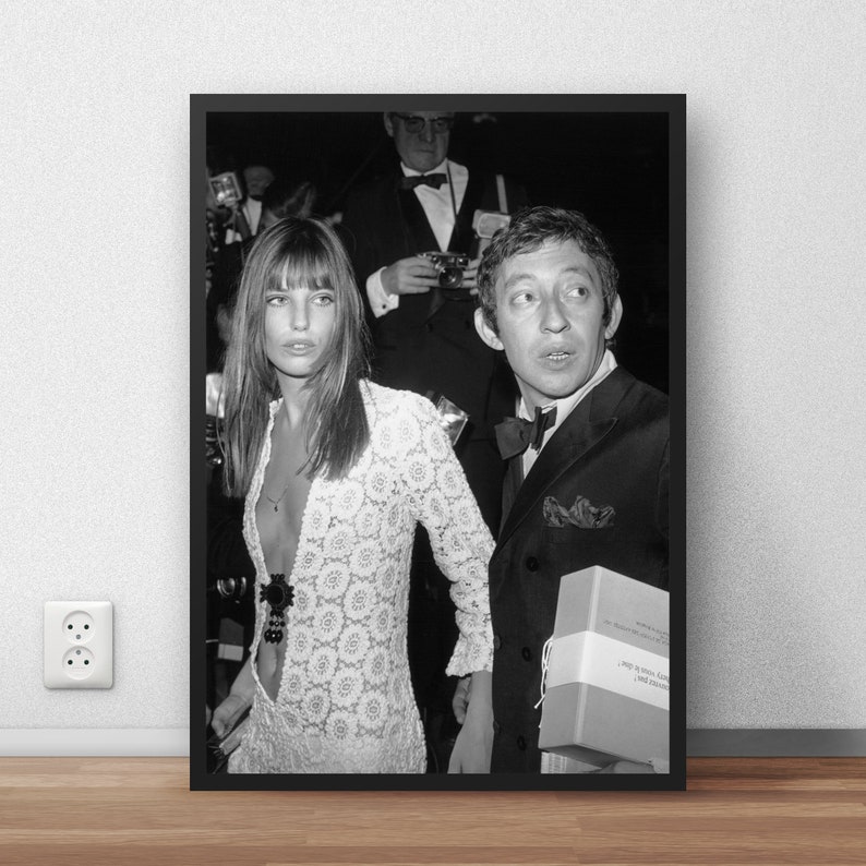 May include: Black and white photo of a couple posing for a photo. The woman is wearing a white lace dress and the man is wearing a suit and tie. He is holding a book titled "The Adventures of Tintin: The Secret of the Unicorn".