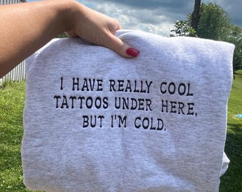 I have really cool tattoos under here but i’m cold, embroidered sweatshirt, tattoo sweater, embroidered sweater, cool tattoos