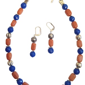 May include: A necklace and earrings set featuring alternating blue and orange gemstone beads with silver accents. The necklace has a toggle clasp and the earrings have lever back closures.