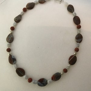 Striped agate necklace, chalcedony and ancient rudraksha seeds. Machined metal inserts.