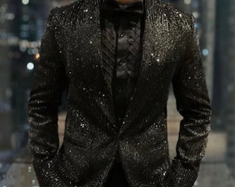 May include: A black sequined blazer with a black bow tie and a black button-down shirt.