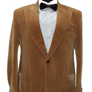 May include: A brown velvet blazer with a single button fastening and a patch pocket on the left side. The blazer has a shawl collar and is displayed on a mannequin.