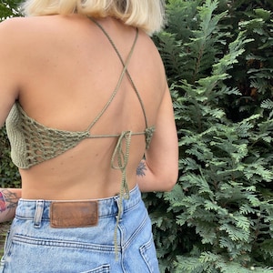 beginner friendly open back beach top crochet pattern. Lightweight summer blouse for beachwear, breathable backless cover-up for vacation or resort style, in Moss Green color from the back.