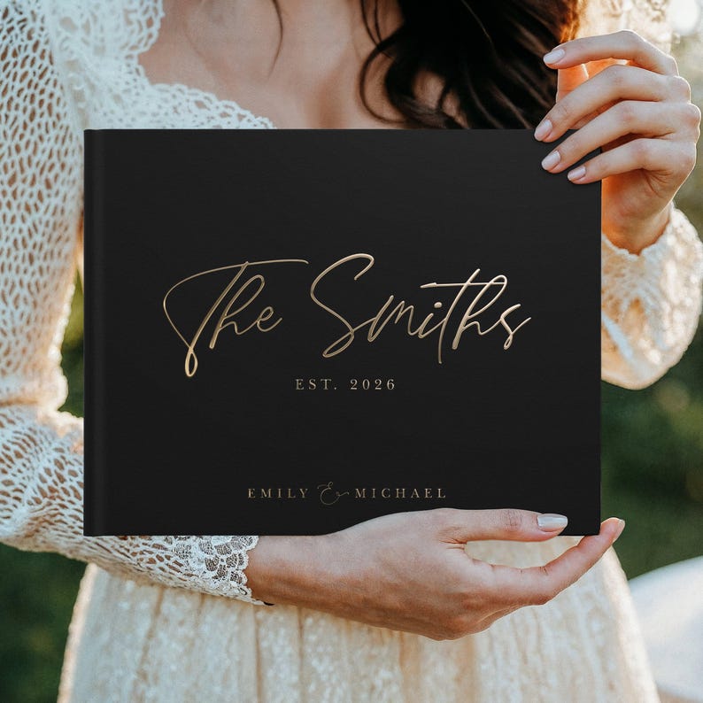 Personalized wedding guest book in black with elegant gold foil design, perfect for a classic wedding ceremony and reception. This custom wedding gift doubles as a timeless wedding album, anniversary gift, and keepsake memory book for guests to sign and leave wishes. A minimalist yet luxurious design fits boho, elegant, and traditional wedding themes, making it the ideal way to preserve love stories and celebrate the couple’s special day for years to come.