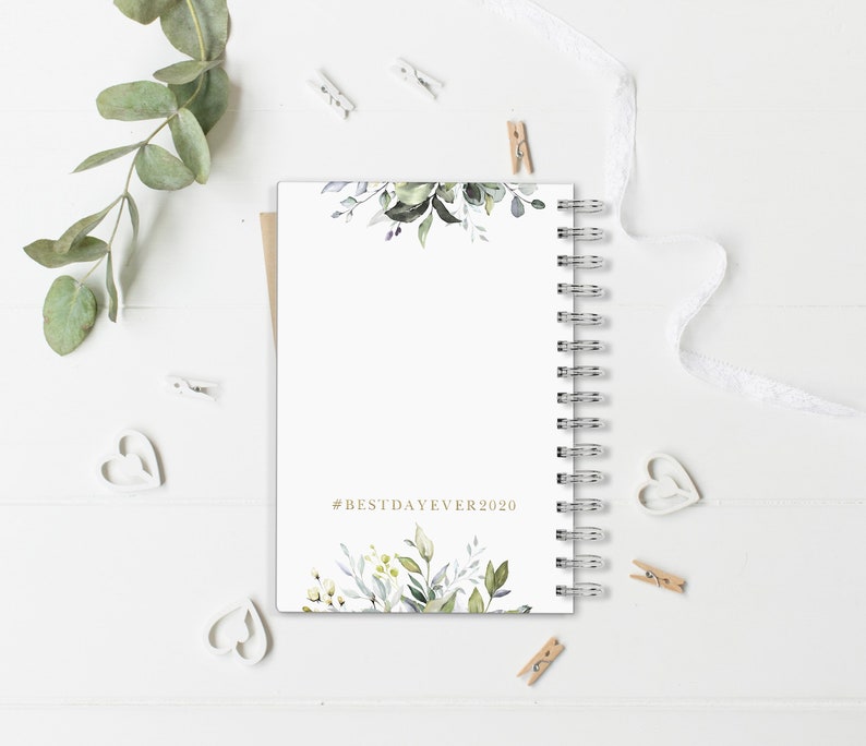 May include: A white spiral bound journal with a watercolor floral design on the front and back covers. The front cover has the text "#BESTDAYEVER2020" in gold lettering.