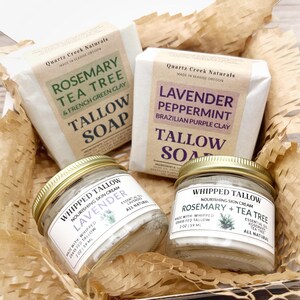 May include: A gift box containing two bars of Quartz Creek Naturals tallow soap in Rosemary Tea Tree and Lavender Peppermint scents, alongside two 2 oz glass jars of whipped tallow nourishing skin cream in matching scents.