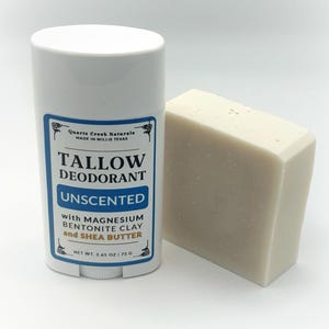 May include: A white plastic deodorant stick container with a label reading Quartz Creek Naturals Tallow Deodorant Unscented with Magnesium Bentonite Clay and Shea Butter, net weight 2.65 oz, next to a rectangular off-white bar of soap.