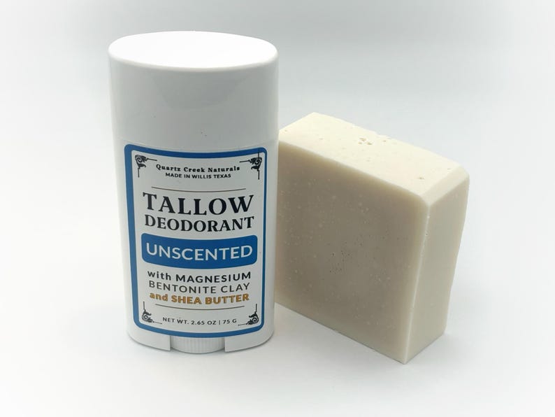 May include: A white plastic deodorant stick container with a label reading Quartz Creek Naturals Tallow Deodorant Unscented with Magnesium Bentonite Clay and Shea Butter, net weight 2.65 oz, next to a rectangular off-white bar of soap.