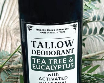 May include: A black cylindrical deodorant stick with a white label reading Quartz Creek Naturals, Tallow Deodorant, Tea Tree & Eucalyptus with Activated Charcoal, and Net Wt. 2.65 oz. The container features a twist-up base and a removable cap.