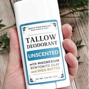 K&ouml;nnte beinhalten: Ein wei&szlig;er Deodorant-Stick aus Kunststoff mit einem rechteckigen Etikett. Das Etikett tr&auml;gt die Aufschrift Quartz Creek Naturals, Tallow Deodorant, Unscented, with Magnesium, Bentonite Clay and Shea Butter, sowie Net Wt. 2.65 oz | 75 g.