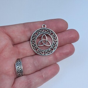 May include: Silver Celtic knot pendant with a circular design. The knot is a traditional symbol of love, friendship, and unity.