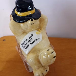 Vtg Coalport of England Paddington Bear, Paddington Takes it Easy, Bone China Figurine, 1976. Says; Please Look After This Bear, Thank You.
