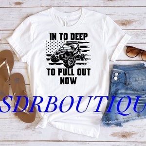 May include: White t-shirt with a black graphic of an off-road vehicle driving through an American flag. The text "In to deep to pull out now" is printed below the vehicle.