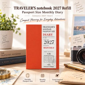 May include: A bright orange Traveler's notebook passport size monthly diary refill for 2027. The cover features a white paper band with black and red text including 'TRAVELER'S notebook', 'DIARY', '2027', 'MONTHLY', and a small calendar grid graphic.