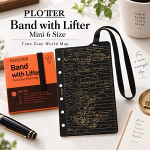 May include: A black Plotter Band with Lifter in Mini 6 size featuring a gold-colored time zone world map print. The accessory includes a black elastic strap and five punched holes along the left edge for binder attachment, presented with its orange packaging.