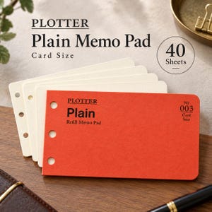 May include: A stack of Plotter Plain Memo Pad refill sheets in card size. The top sheet is bright orange with black text reading Plotter, Plain, Refill Memo Pad, and No 003. The sheets feature a vertical row of circular punch holes on the left side.