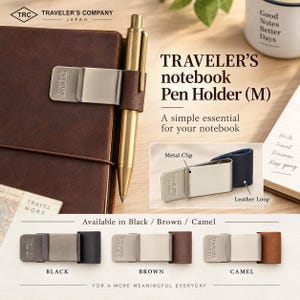 May include: A Traveler's Company metal pen holder with a leather loop, attached to a brown notebook. The product features a silver-toned metal clip embossed with the brand name and is available in black, brown, and camel leather color options.