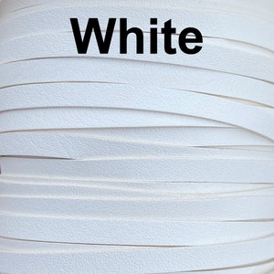 May include: Close-up of a roll of white leather strips. The strips are layered and have a textured surface. The word "White" is printed in large, bold, black letters across the top of the image.