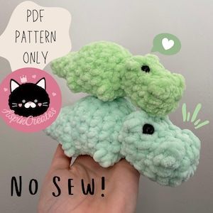 May include: PDF pattern for a no-sew crochet hippopotamus toy. The pattern includes two hippos, one green and one light green. The hippos are stacked on top of each other.