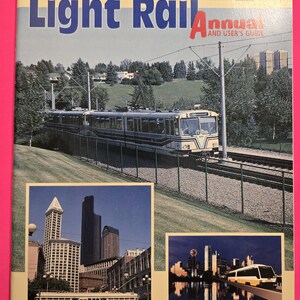 May include: A 1993 North American Light Rail Annual and User's Guide magazine featuring a light rail train on the cover. The cover includes three photographs of trains in urban settings, with text reading 1993 North American Light Rail Annual.