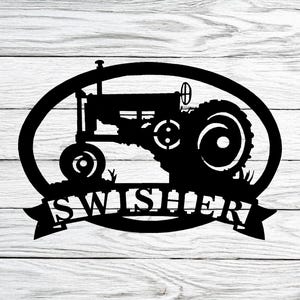 May include: Black metal silhouette of a tractor in an oval frame with the name "Swisher" on a banner below.