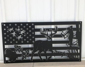May include: Black metal wall art featuring a deer, turkey, and bear silhouetted against an American flag design.