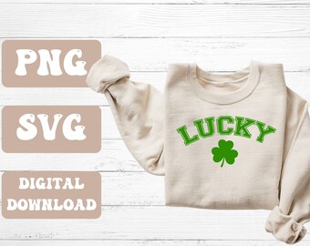 May include: A digital download of a "LUCKY" graphic with a shamrock, available in PNG and SVG formats. The graphic is shown on a beige sweatshirt.