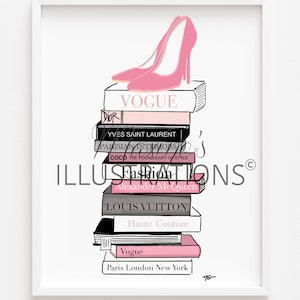 May include: A framed illustration of a stack of fashion books, including "Vogue" and "Louis Vuitton", topped with a pink high-heeled shoe. The artwork uses a minimalist style with black and pink accents. The image is in a white frame.