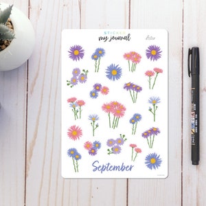 May include: A sheet of stickers featuring purple, pink, and blue aster flowers with green stems. The stickers are labeled "Sticker my journal" and "Aster". The sheet also includes the word "September".
