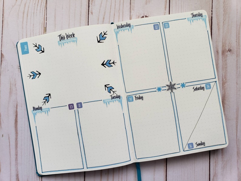 May include: A weekly planner with a winter theme. The planner has a blue and white color scheme with icicles and snowflakes. The days of the week are labeled: Monday, Tuesday, Wednesday, Thursday, Friday, Saturday, and Sunday. The dates are 10, 11, 12, 13, 14, 15, and 16.