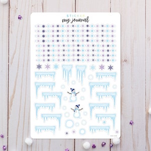 May include: A sticker sheet titled "my journal" featuring winter-themed designs including rows of purple and blue snowflakes, various light blue icicle borders, two small snowmen wearing blue hats and scarves, and several light blue circles.