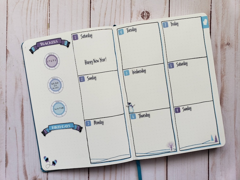 May include: A weekly planner with a winter theme. The planner has a blue cover and is open to the week of January 1st. The days of the week are labeled with numbers and the days of the week. The planner has a section for trackers and birthdays. The trackers include steps, read 30 mins, and water. The planner has a wintery design with snowflakes and a snowman.
