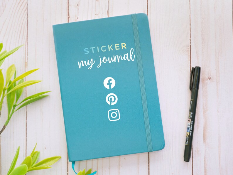 May include: A teal blue journal with the text "STICKER my journal" and social media icons for Facebook, Pinterest, and Instagram.