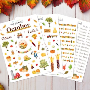 May include: Four sheets of stickers with a fall theme. The stickers feature images of pumpkins, corn, hay bales, scarecrows, and other fall-themed items. The stickers are designed for use in a journal or planner. The text on the stickers includes "October", "Goals", "Tasks", "Hay Rides", "Thursday", "Friday", "This Week", and "Trackers".