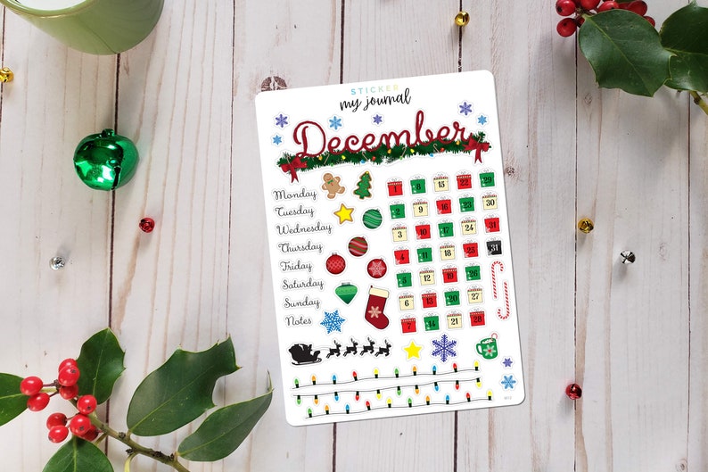 May include: A white sticker sheet with a December calendar and Christmas-themed illustrations. The calendar features a grid with numbers 1 through 30, and the illustrations include presents, ornaments, a gingerbread man, a stocking, and a snowflake.