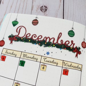 May include: A December calendar page with a green garland and red ornaments. The days of the week are labeled Sunday, Monday, Tuesday, Wednesday, and Thursday. The numbers 4, 5, 6, 7, 1, and 8 are written in boxes on the calendar.