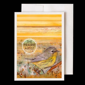 May include: Watercolor art greeting card featuring a yellow-throated warbler perched on a branch. The card has a white border and envelope. The text "The Prairie Artist" is in a circular design. The background has yellow and orange hues.