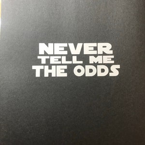 May include: A black background with the white text "NEVER TELL ME THE ODDS" in a bold font.