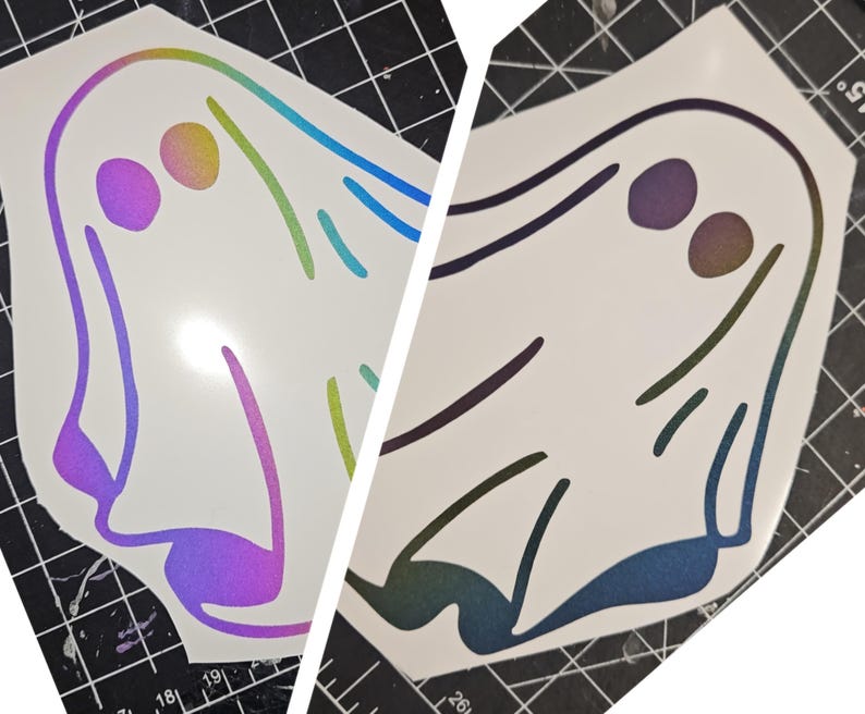 May include: Two iridescent vinyl ghost stickers. The ghost on the left has a rainbow iridescent finish and the ghost on the right has a blue and purple iridescent finish.