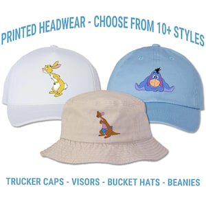 May include: Three hats with cartoon character designs. A white trucker hat with a yellow rabbit, a light blue cap with a purple donkey, and a beige bucket hat with a kangaroo. Text reads "PRINTED HEADWEAR - CHOOSE FROM 10+ STYLES" and "TRUCKER CAPS - VISORS - BUCKET HATS - BEANIES".