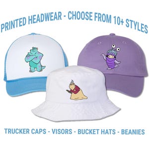 May include: Three hats with cartoon character designs. A blue and white trucker hat features a green monster. A purple baseball cap has a cartoon character. A white bucket hat has a cartoon character. Text reads "PRINTED HEADWEAR - CHOOSE FROM 10+ STYLES".