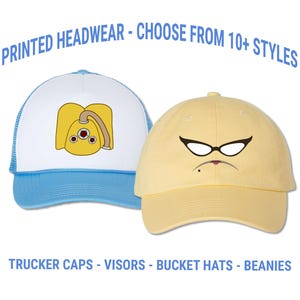May include: Two printed headwear hats are displayed against a white background. One is a blue and white trucker hat with a yellow cartoon design. The other is a yellow baseball cap with a cartoon face. Text reads: PRINTED HEADWEAR - CHOOSE FROM 10+ STYLES, TRUCKER CAPS - VISORS - BUCKET HATS - BEANIES.
